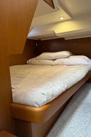 Horizon IV Yacht Photos Pics Cozy bedroom in 2020 Beneteau Swift Trawler 47 with wooden accents and soft lighting.