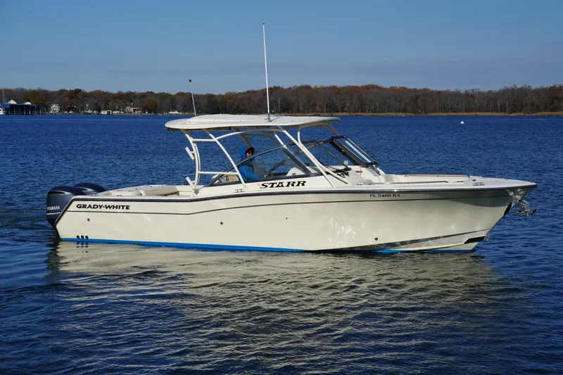 Starr Yacht Photos Pics 2015 Grady-White Freedom 307 boat on calm water, side view.