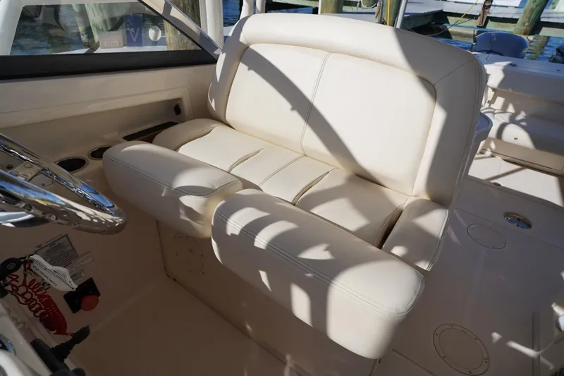 Starr Yacht Photos Pics 2015 Grady-White Freedom 307 boat interior with cream leather seating and steering wheel.
