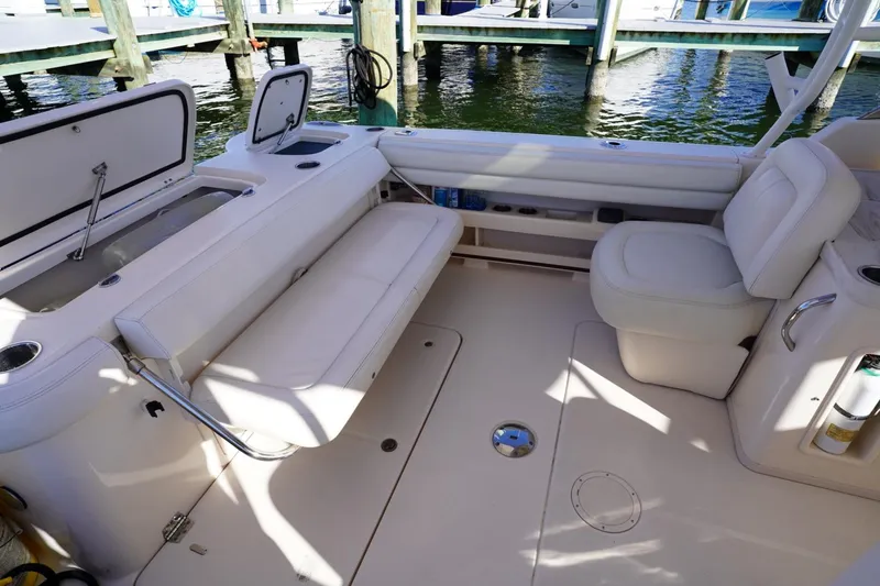 Starr Yacht Photos Pics 2015 Grady-White Freedom 307 boat interior with white seating and storage compartments.