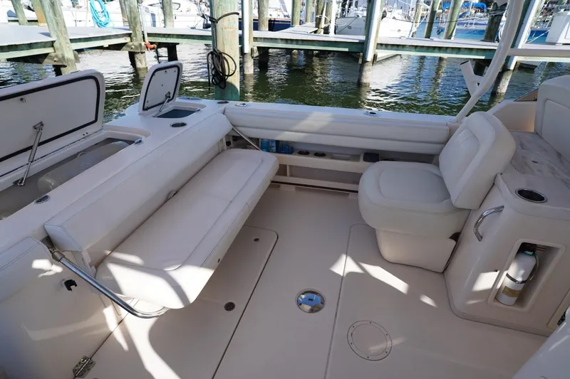 Starr Yacht Photos Pics 2015 Grady-White Freedom 307 boat interior with seating and storage, docked at marina.