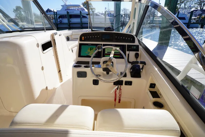 Starr Yacht Photos Pics 2015 Grady-White Freedom 307 boat cockpit with steering wheel and navigation system.