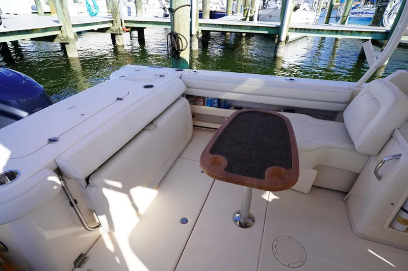 Starr Yacht Photos Pics 2015 Grady-White Freedom 307 boat interior with seating and table at marina.