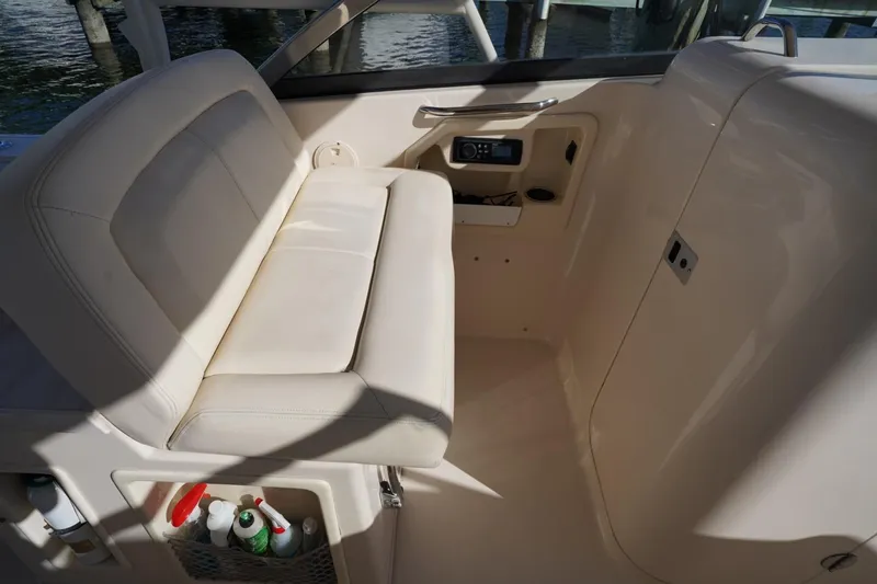 Starr Yacht Photos Pics 2015 Grady-White Freedom 307 boat interior with beige seating and storage compartments.