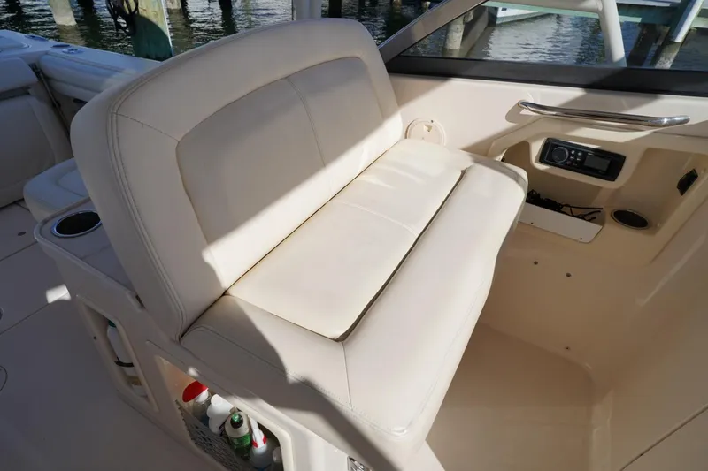 Starr Yacht Photos Pics 2015 Grady-White Freedom 307 boat interior with beige seating and storage compartments.