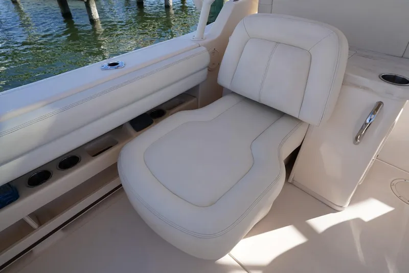 Starr Yacht Photos Pics Luxurious seating on 2015 Grady-White Freedom 307 boat, featuring white upholstery and cup holders.