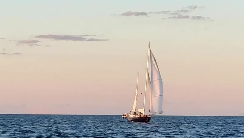  Yacht Photos Pics 1984 Irwin Cutter Ketch sailing at sunset on calm ocean waters.