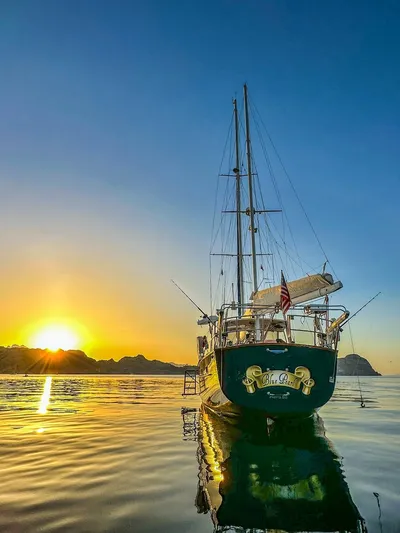  Yacht Photos Pics 1984 Irwin Cutter Ketch sailboat at sunset on calm waters.