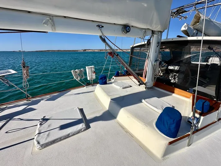  Yacht Photos Pics 1984 Irwin Cutter Ketch sailboat deck with seating, sailing on clear blue waters.