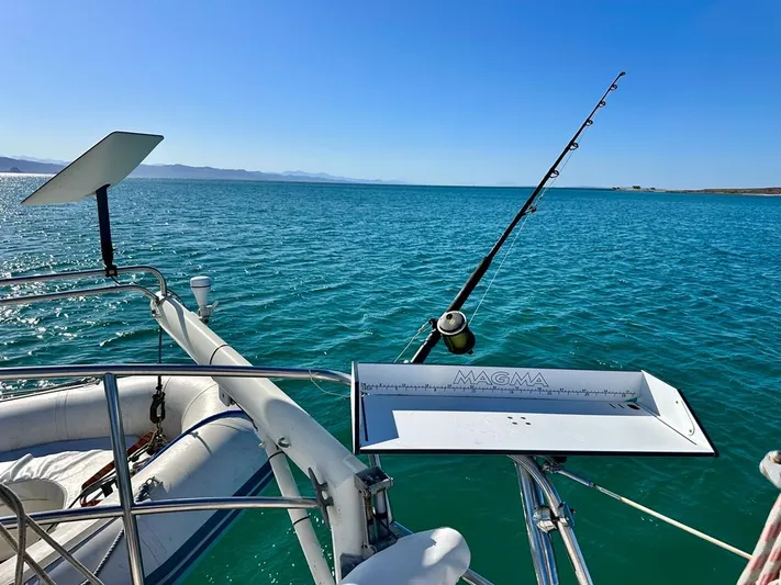  Yacht Photos Pics 1984 Irwin Cutter Ketch sailboat with fishing gear on calm blue sea.
