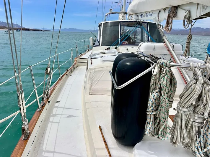  Yacht Photos Pics 1984 Irwin Cutter Ketch sailboat deck with ropes and fender on calm sea.