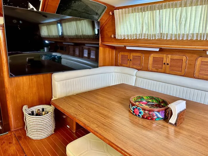  Yacht Photos Pics Interior of 1984 Irwin Cutter Ketch with wooden table, seating, and decorative bowl.