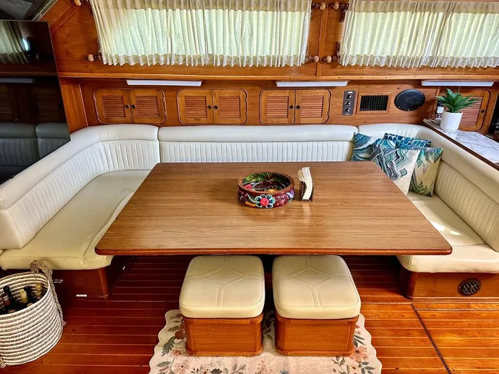  Yacht Photos Pics 1984 Irwin Cutter Ketch interior with wooden table, cushioned seating, and nautical decor.
