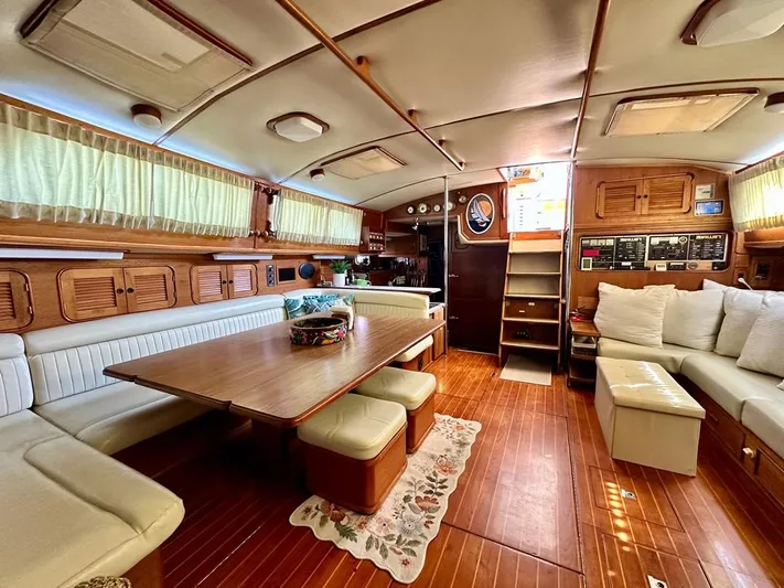  Yacht Photos Pics Luxurious interior of 1984 Irwin Cutter Ketch sailboat with wood finishes and comfortable seating.