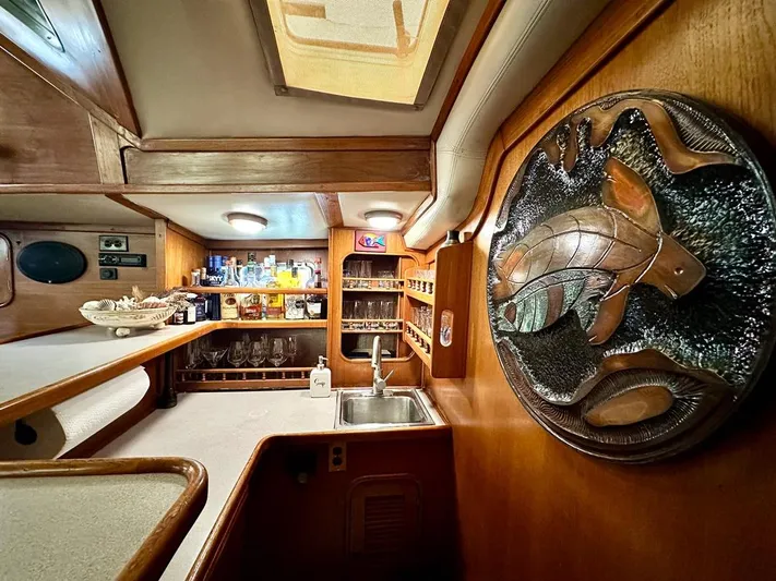  Yacht Photos Pics Interior of 1984 Irwin Cutter Ketch yacht with wooden decor and bar area.