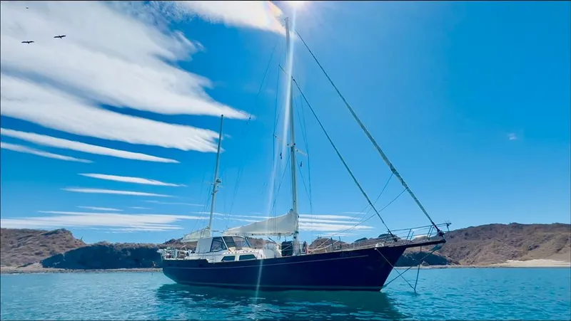  Yacht Photos Pics 1984 Irwin Cutter Ketch sailboat on calm water under clear blue sky.