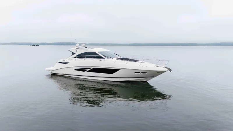  Yacht Photos Pics 2013 Sea Ray 510 Sundancer yacht on calm water, showcasing sleek design and luxury features.