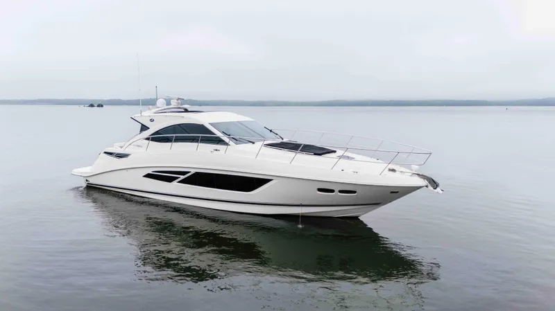  Yacht Photos Pics 2013 Sea Ray 510 Sundancer yacht on calm water, side view.
