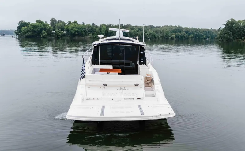  Yacht Photos Pics 2013 Sea Ray 510 Sundancer yacht on calm lake with lush green shoreline.