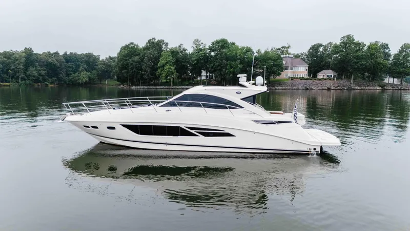  Yacht Photos Pics 2013 Sea Ray 510 Sundancer yacht on calm lake with wooded shoreline.