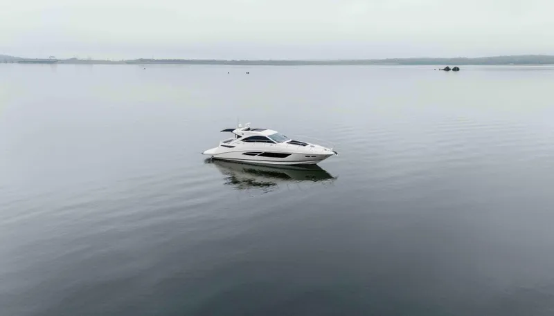  Yacht Photos Pics 2013 Sea Ray 510 Sundancer yacht on calm water, overcast sky.