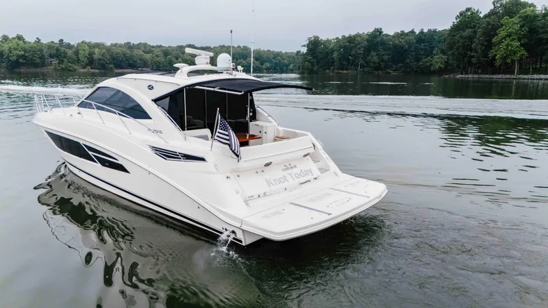  Yacht Photos Pics 2013 Sea Ray 510 Sundancer yacht cruising on a serene lake.