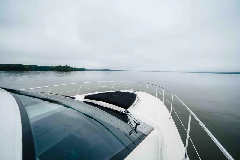  Yacht Photos Pics 2013 Sea Ray 510 Sundancer cruising on a calm lake under overcast skies.