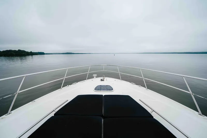  Yacht Photos Pics Bow view of 2013 Sea Ray 510 Sundancer on calm waters under cloudy sky.