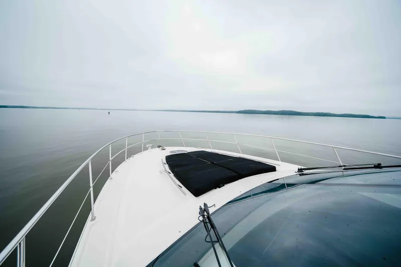  Yacht Photos Pics 2013 Sea Ray 510 Sundancer yacht cruising on calm waters under a cloudy sky.