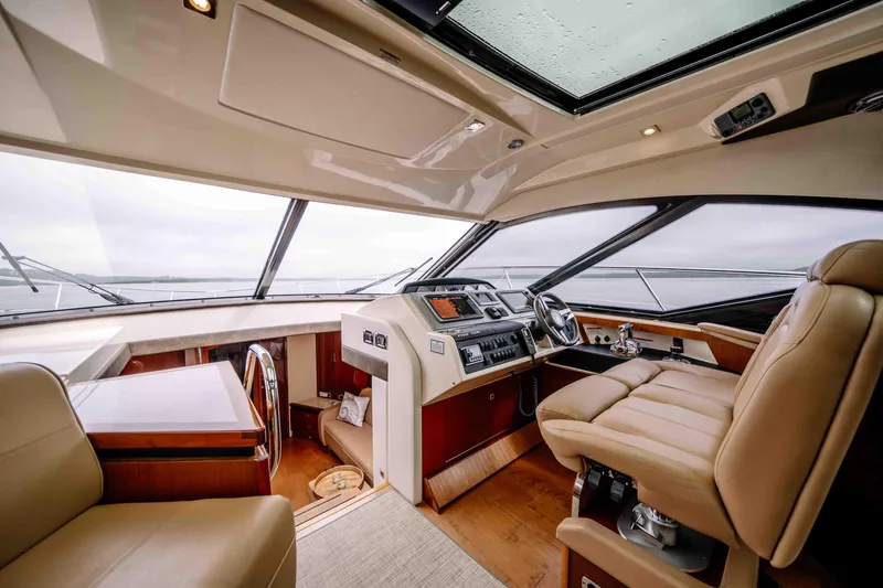  Yacht Photos Pics Luxurious interior of 2013 Sea Ray 510 Sundancer yacht with leather seating and modern controls.