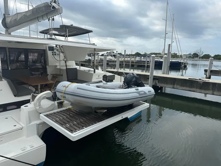 Brave Coquina Yacht Photos Pics Fountaine Pajot Lucia 40 catamaran with dinghy at marina, 2020 model.
