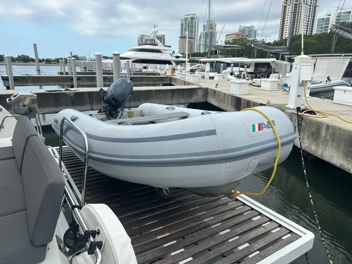 Brave Coquina Yacht Photos Pics Inflatable dinghy on a 2020 Fountaine Pajot Lucia 40 catamaran at a marina.