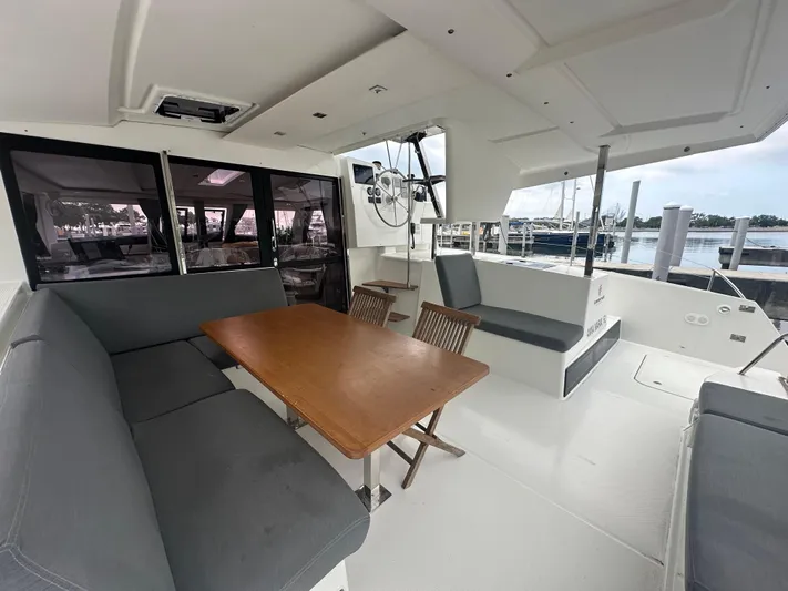 Brave Coquina Yacht Photos Pics Spacious cockpit of 2020 Fountaine Pajot Lucia 40 catamaran with seating and dining area.