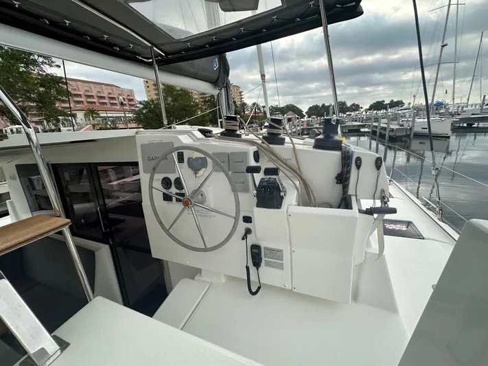 Brave Coquina Yacht Photos Pics Helm station of 2020 Fountaine Pajot Lucia 40 catamaran docked at marina.