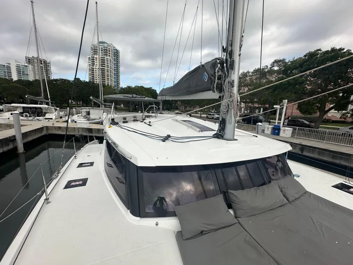 Brave Coquina Yacht Photos Pics 2020 Fountaine Pajot Lucia 40 catamaran docked at marina with cityscape background.