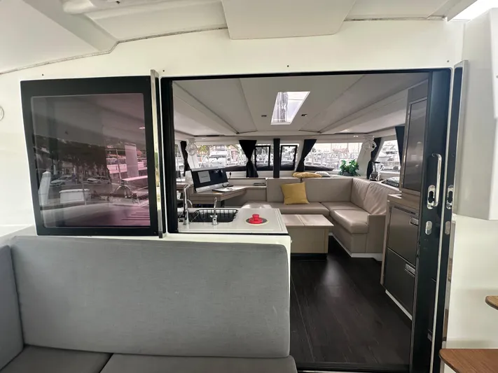 Brave Coquina Yacht Photos Pics Interior of 2020 Fountaine Pajot Lucia 40 catamaran with modern seating and large windows.