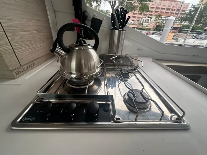 Brave Coquina Yacht Photos Pics Modern kitchen in 2020 Fountaine Pajot Lucia 40 with stainless steel stove and kettle.