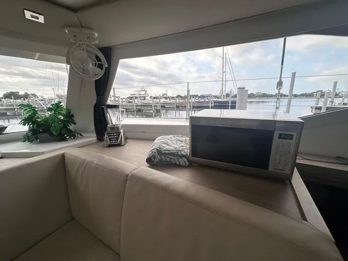 Brave Coquina Yacht Photos Pics Interior of 2020 Fountaine Pajot Lucia 40 catamaran with microwave and marina view.