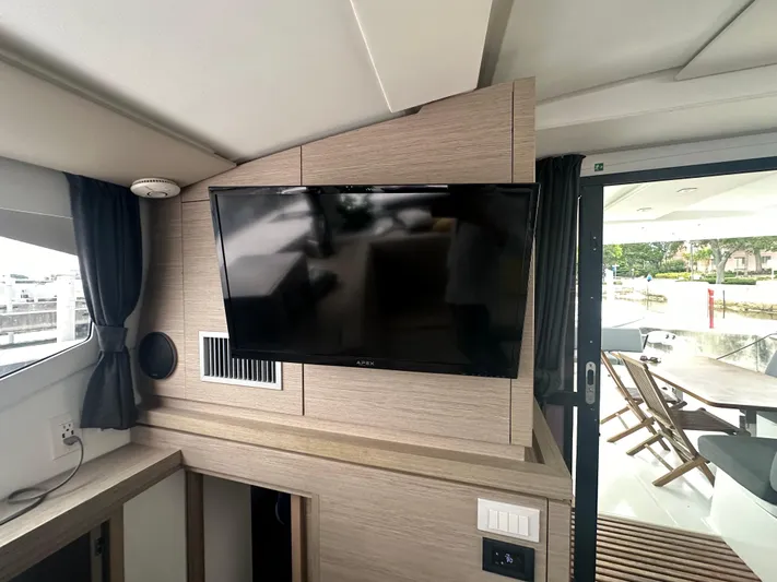 Brave Coquina Yacht Photos Pics Flat-screen TV in the interior of a 2020 Fountaine Pajot Lucia 40 catamaran.