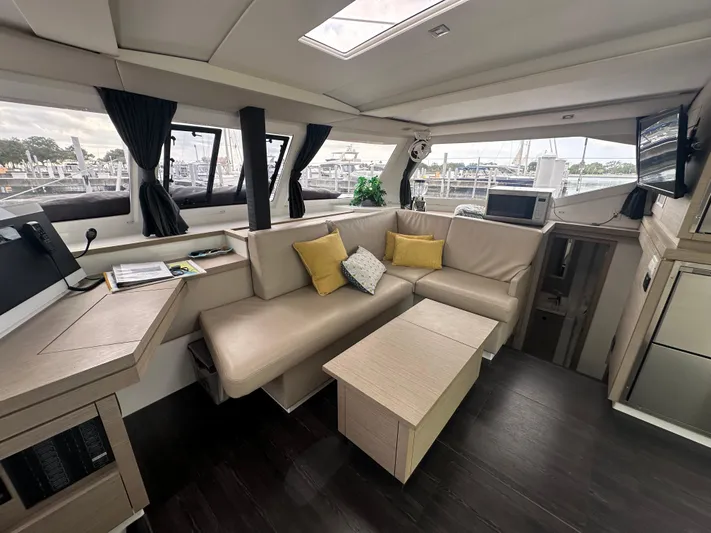 Brave Coquina Yacht Photos Pics Modern interior of 2020 Fountaine Pajot Lucia 40 catamaran with comfortable seating area.