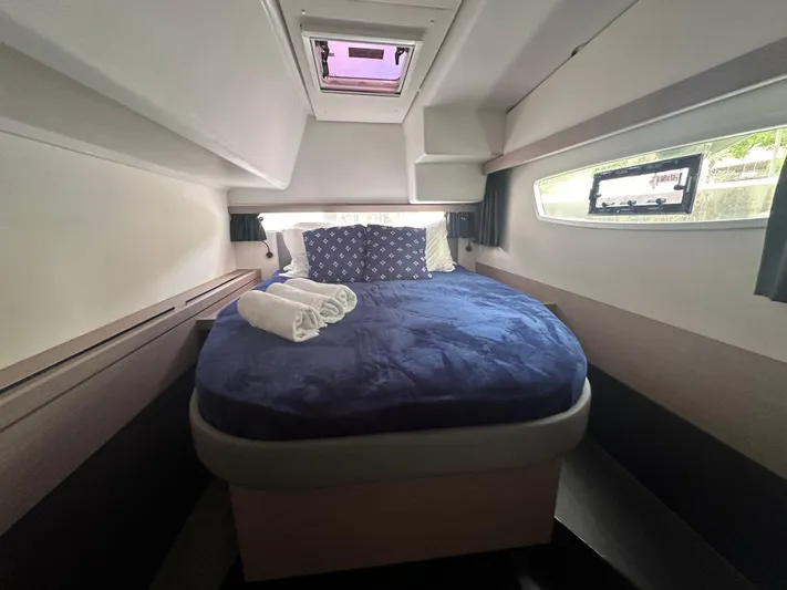 Brave Coquina Yacht Photos Pics 2020 Fountaine Pajot Lucia 40 cabin with a cozy bed and porthole windows.