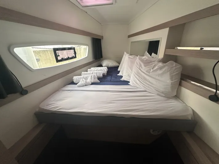 Brave Coquina Yacht Photos Pics Interior cabin of 2020 Fountaine Pajot Lucia 40 catamaran with neatly arranged bed.