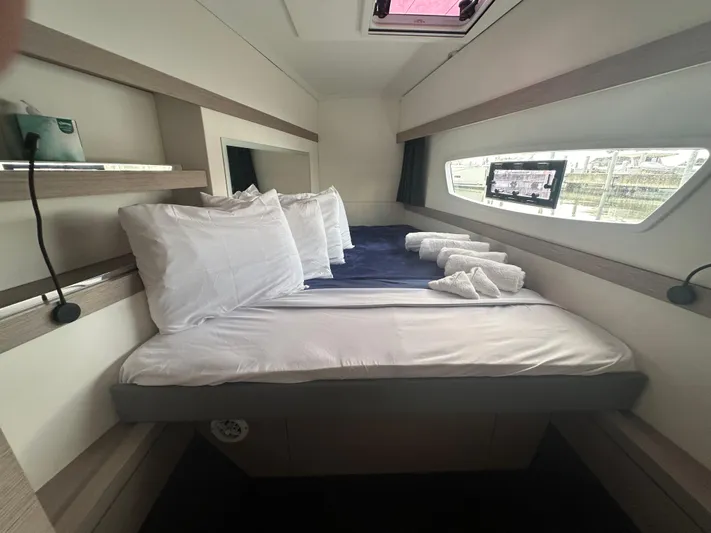 Brave Coquina Yacht Photos Pics 2020 Fountaine Pajot Lucia 40 cabin with bed, pillows, and window view.