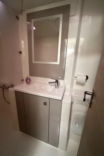 Brave Coquina Yacht Photos Pics Modern bathroom in 2020 Fountaine Pajot Lucia 40 catamaran with sink, mirror, and storage.
