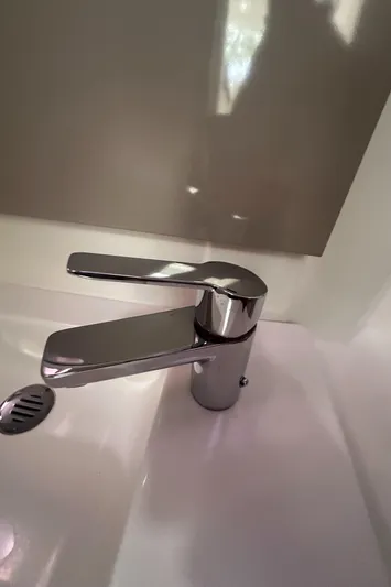 Brave Coquina Yacht Photos Pics Modern chrome faucet in the bathroom of a 2020 Fountaine Pajot Lucia 40 catamaran.
