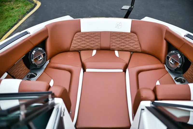  Yacht Photos Pics Luxurious interior of 2022 MasterCraft X24 boat with brown leather seating and speakers.