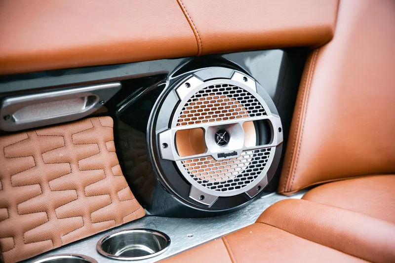  Yacht Photos Pics 2022 MasterCraft X24 interior with premium Klipsch speaker and luxurious brown leather seating.