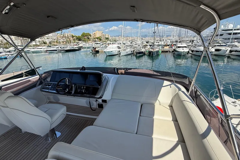 Three Amigos Yacht Photos Pics Luxurious 2021 Princess S62 yacht interior with marina view, featuring plush seating and modern helm.