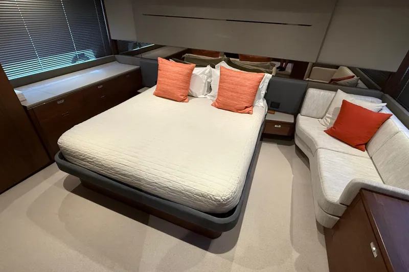 Three Amigos Yacht Photos Pics Luxurious bedroom interior of 2021 Princess S62 yacht with modern decor and orange accents.
