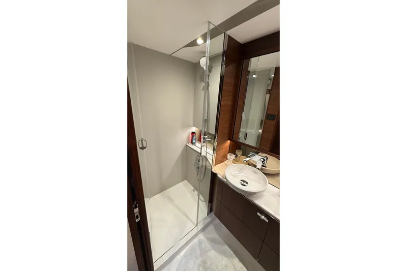 Three Amigos Yacht Photos Pics Luxurious bathroom in 2021 Princess S62 yacht with modern fixtures and glass shower.